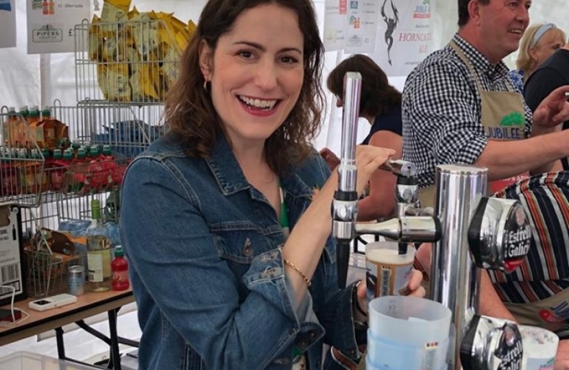 Victoria Atkins MP pulling pints in the Dad's Army bar at the Woodhall Forties Festival