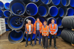 Victoria in front of pipes with Polypipe Staff