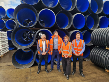 Victoria in front of pipes with Polypipe Staff